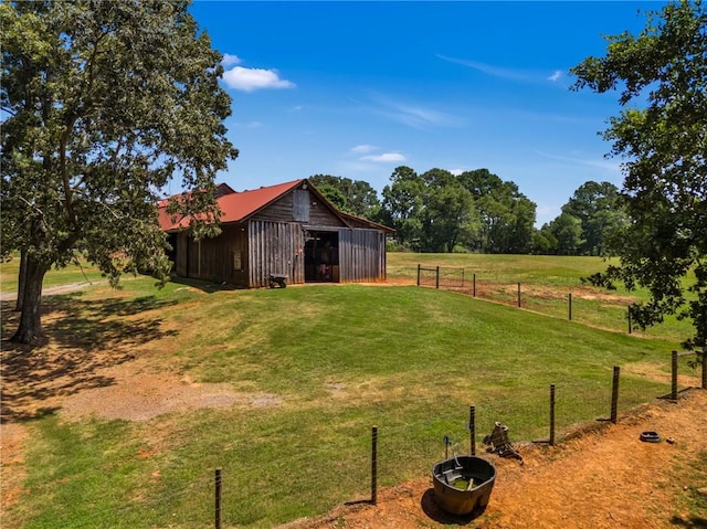 view of yard featuring an outbuilding and a rural view