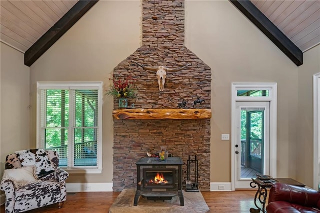 living room with high vaulted ceiling, hardwood / wood-style floors, and beamed ceiling