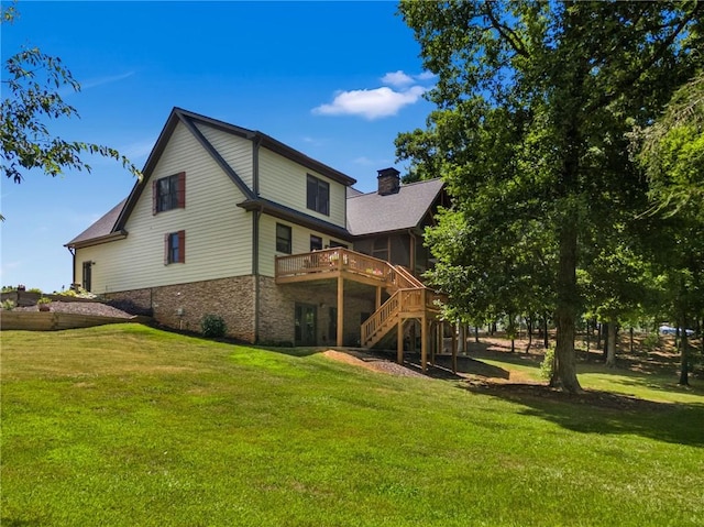 back of house with a lawn and a wooden deck