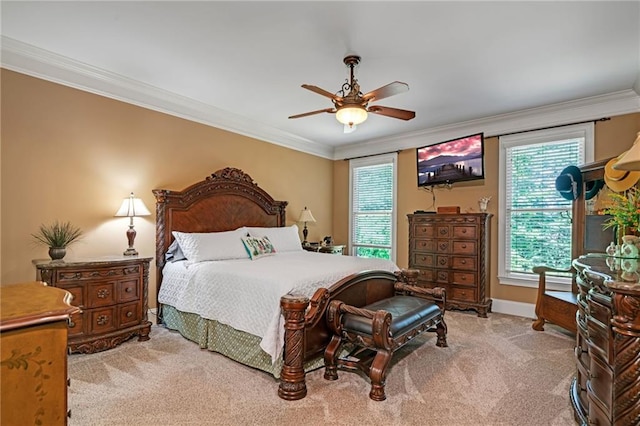 bedroom with ornamental molding, ceiling fan, and light colored carpet