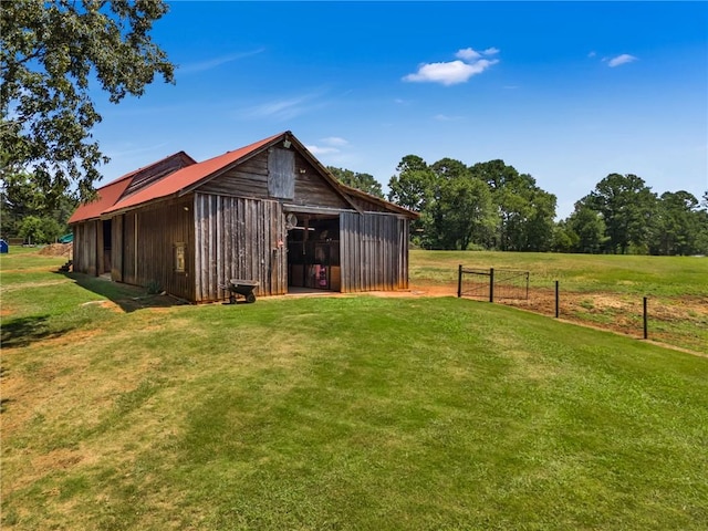 view of outbuilding featuring a yard