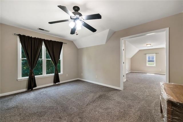 additional living space with a healthy amount of sunlight, carpet floors, and lofted ceiling