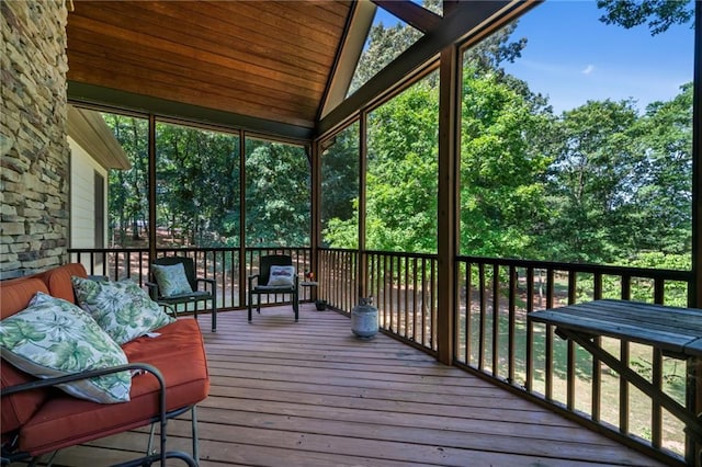 sunroom featuring plenty of natural light and lofted ceiling