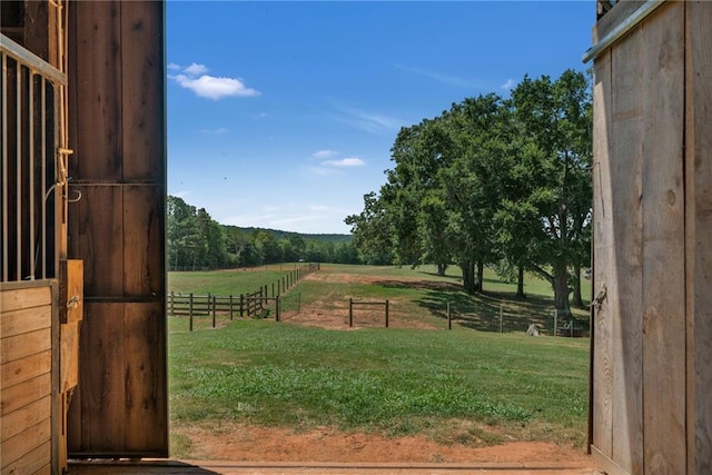 view of yard featuring an outbuilding and a rural view