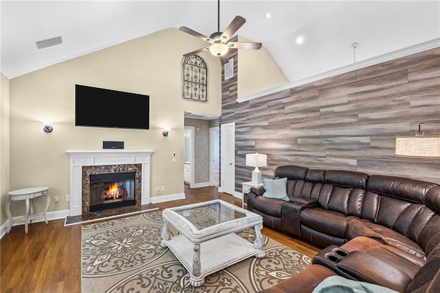 living room with a ceiling fan, visible vents, wood finished floors, high vaulted ceiling, and baseboards