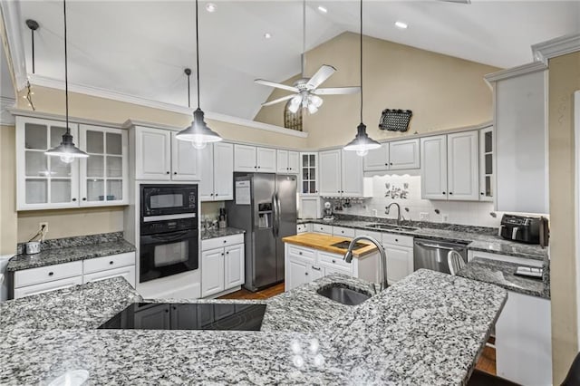 kitchen with a sink, decorative backsplash, a ceiling fan, and black appliances