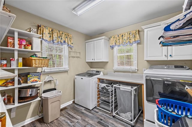 laundry room featuring cabinet space, baseboards, dark wood-type flooring, and washing machine and clothes dryer