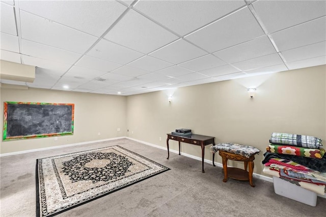 interior space featuring carpet floors, baseboards, and a drop ceiling