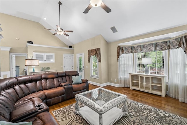 living room with a ceiling fan, high vaulted ceiling, visible vents, and wood finished floors