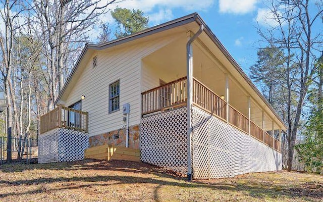 view of side of property with a balcony