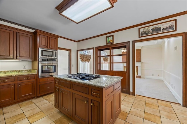 kitchen featuring visible vents, crown molding, light stone countertops, stainless steel appliances, and light tile patterned flooring