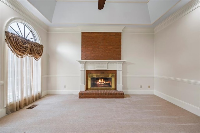 unfurnished living room featuring a ceiling fan, visible vents, a brick fireplace, baseboards, and carpet flooring