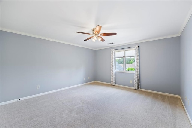 carpeted empty room featuring baseboards, visible vents, ornamental molding, and ceiling fan
