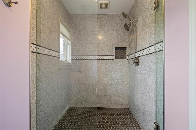 bathroom featuring visible vents and a shower stall