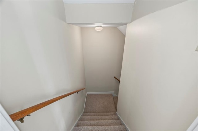staircase with carpet floors and baseboards