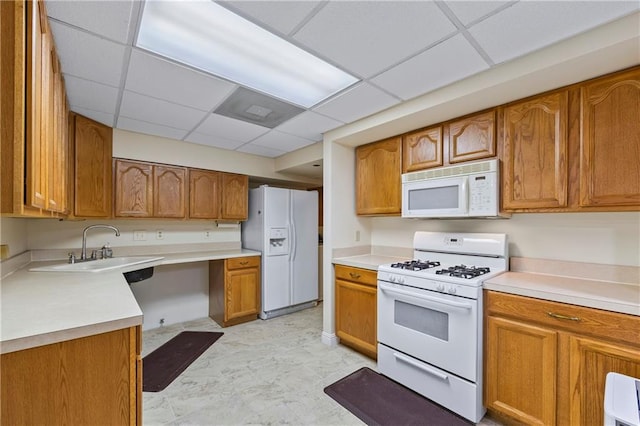 kitchen with white appliances, brown cabinetry, and light countertops