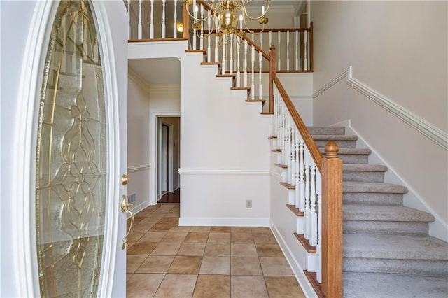 interior space featuring an inviting chandelier, crown molding, and tile patterned flooring
