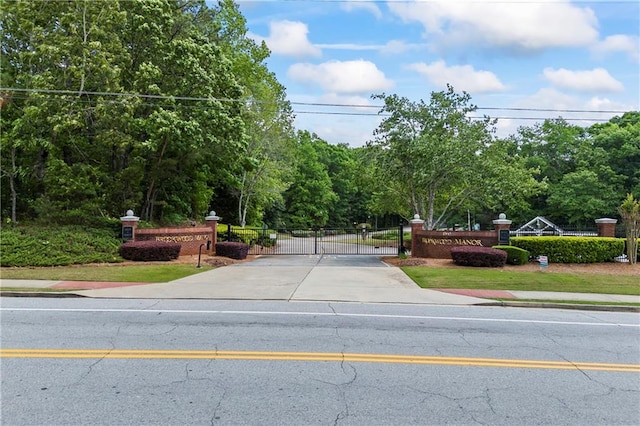 view of road with a gate and sidewalks