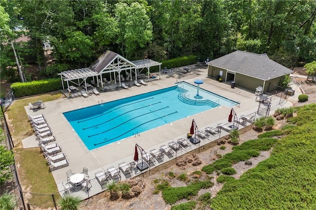 pool featuring a pergola, fence, and a patio