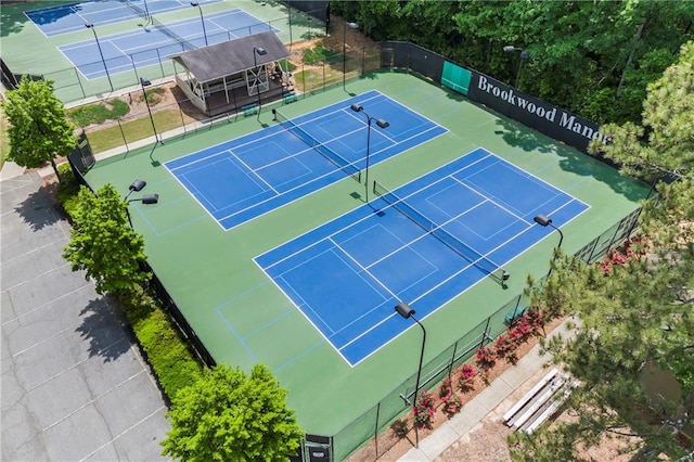 view of sport court featuring fence