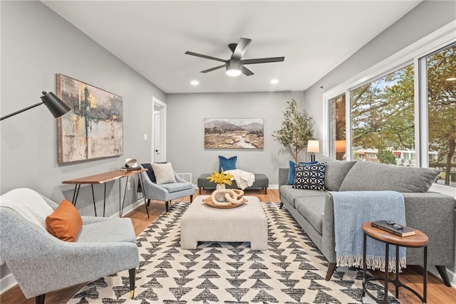 living room featuring ceiling fan and light hardwood / wood-style flooring