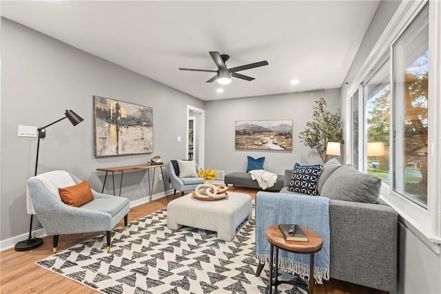 living room featuring hardwood / wood-style floors and ceiling fan