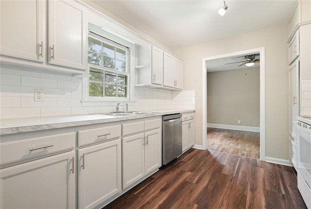 kitchen featuring dishwasher, a sink, a ceiling fan, light countertops, and dark wood-type flooring