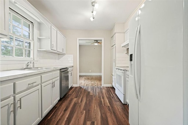 kitchen featuring white appliances, tasteful backsplash, dark wood-style floors, a ceiling fan, and light countertops