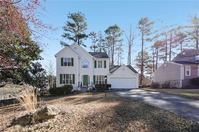 colonial-style house with a garage and concrete driveway