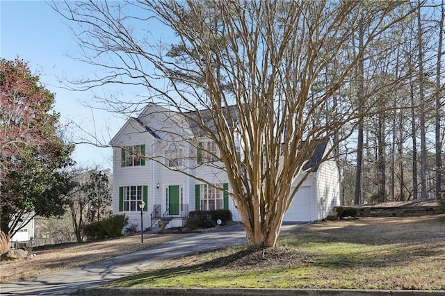 view of front of property with a garage, driveway, and a front yard