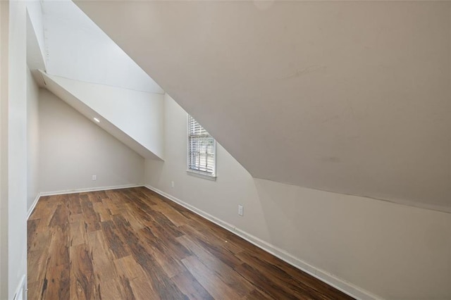 additional living space featuring vaulted ceiling and wood-type flooring