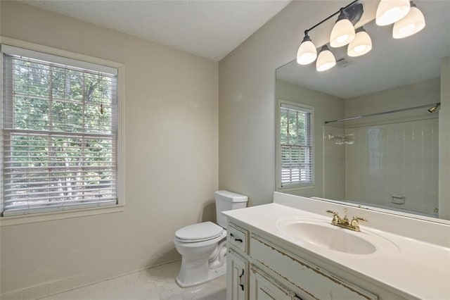 bathroom with a shower, tile patterned floors, toilet, and vanity