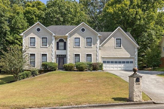 colonial-style house with a garage and a front yard