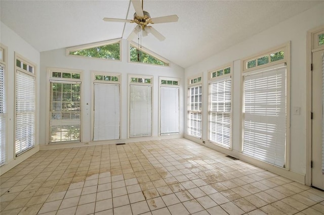 unfurnished sunroom featuring plenty of natural light, vaulted ceiling, and ceiling fan