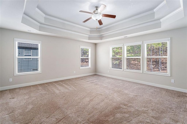 unfurnished room featuring carpet, baseboards, a tray ceiling, and ornamental molding