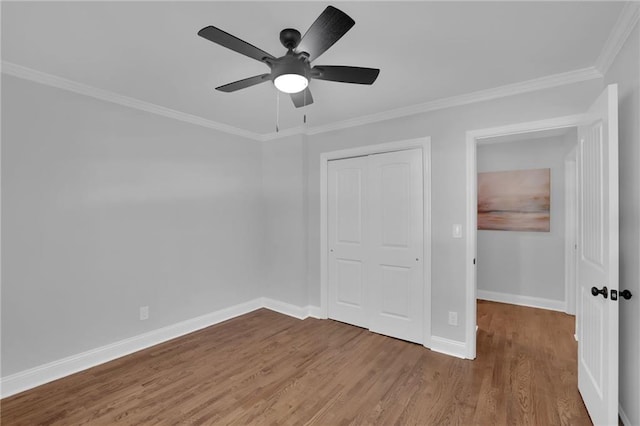 4669 Dunover Cir, Atlanta, GA 30360 - unfurnished bedroom with wood finished floors, ornamental molding, a closet, and a ceiling fan