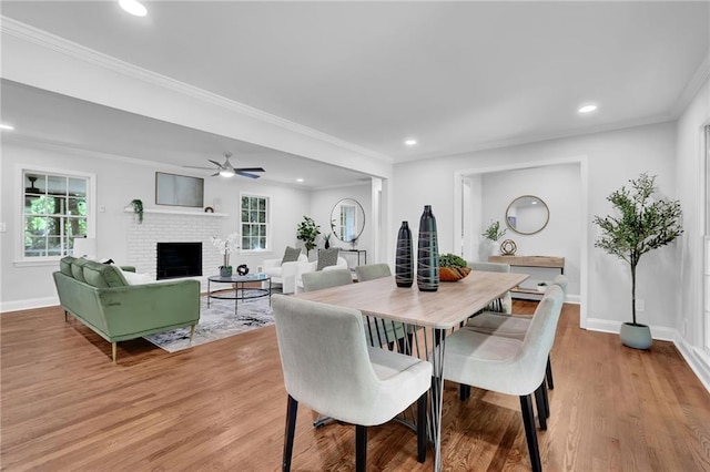 4669 Dunover Cir, Atlanta, GA 30360 - dining space with healthy amount of natural light, a brick fireplace, a ceiling fan, light wood finished floors, and recessed lighting