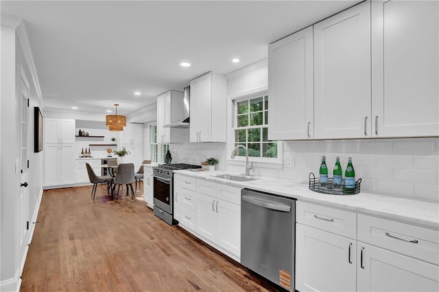 4669 Dunover Cir, Atlanta, GA 30360 - kitchen featuring stainless steel appliances, wall chimney exhaust hood, crown molding, white cabinets, and decorative backsplash