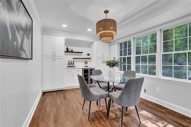 4669 Dunover Cir, Atlanta, GA 30360 - dining area with wine cooler, crown molding, wood finished floors, recessed lighting, and a bar