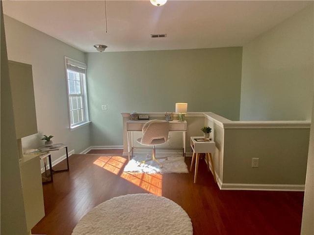 home office featuring baseboards, visible vents, and wood finished floors