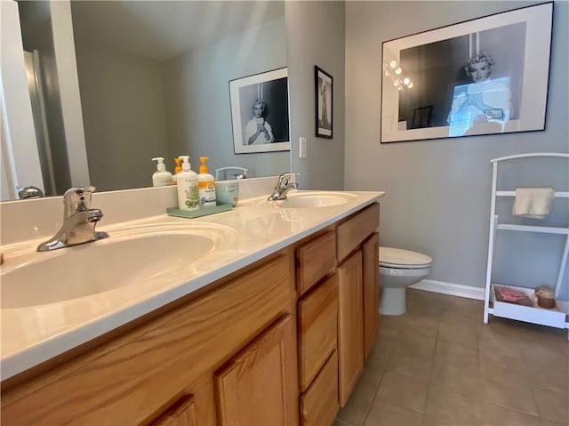 full bath with toilet, tile patterned flooring, double vanity, and a sink