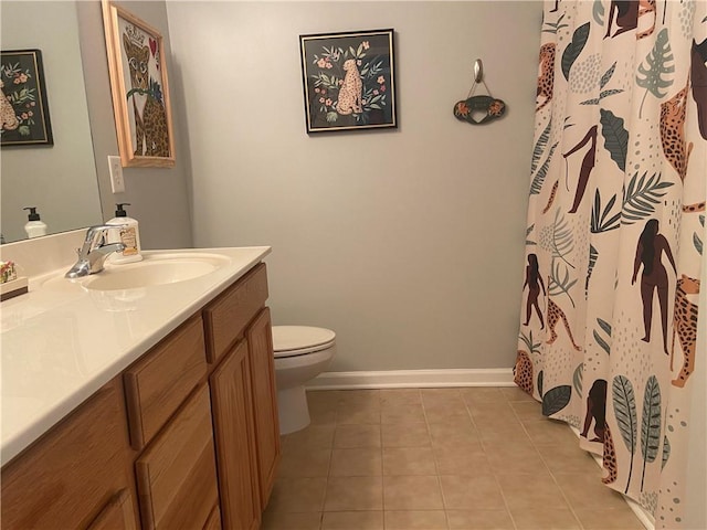 bathroom with curtained shower, toilet, vanity, baseboards, and tile patterned floors