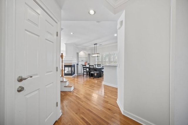 corridor featuring recessed lighting, baseboards, and light wood finished floors