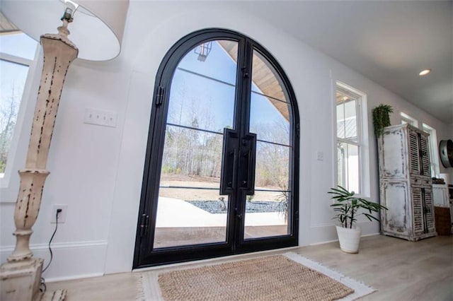 entryway featuring french doors, wood finished floors, and recessed lighting