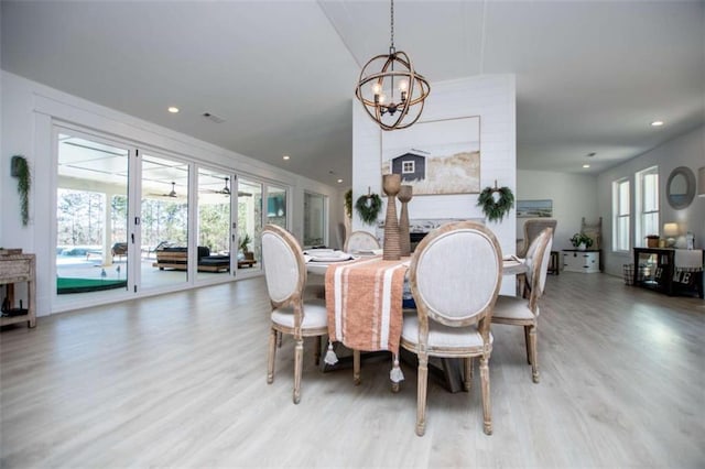 dining room with recessed lighting, light wood-type flooring, visible vents, and a notable chandelier