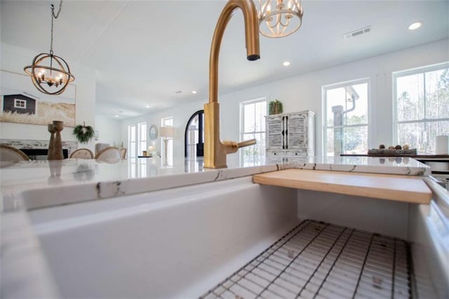 kitchen with an inviting chandelier, visible vents, decorative light fixtures, and recessed lighting