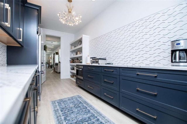 kitchen featuring oven, a notable chandelier, light wood-style floors, backsplash, and open shelves