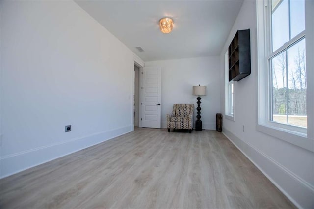 interior space with light wood-type flooring and baseboards