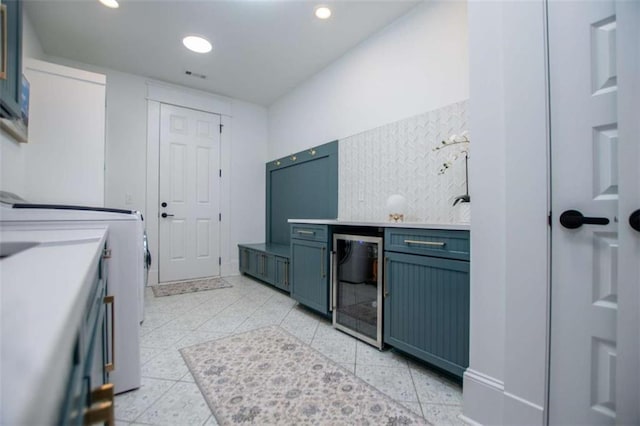 kitchen with visible vents, decorative backsplash, wine cooler, washer / clothes dryer, and recessed lighting