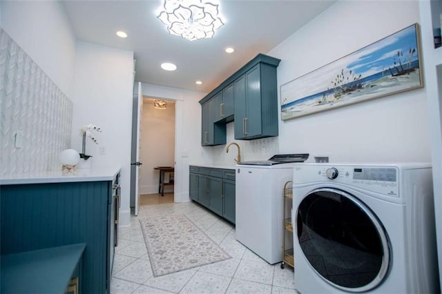 laundry area featuring washing machine and dryer, cabinet space, baseboards, and recessed lighting